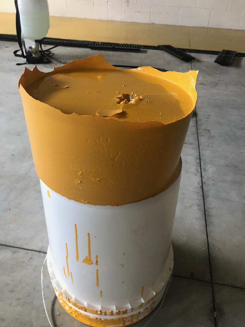 Solidified epoxy in bucket — result of mixing too much at once